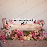 بک دراپ عکاسی تخت نوزاد با دکور گل های بهاری